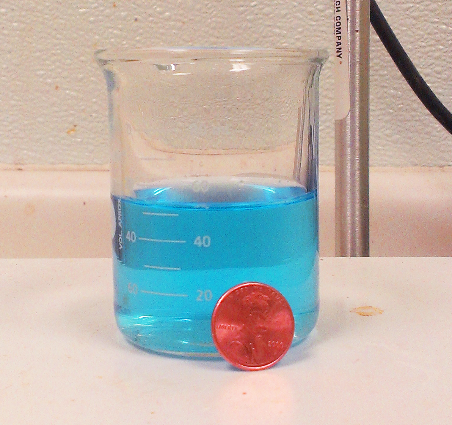 Dissolved Copper, in solution next to a copper penny